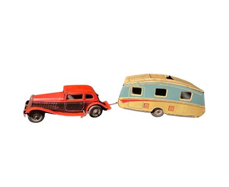 A vintage, UK made, Mettoy Tin Toy saloon car and tin toy caravan with trailer hitch, plus clockwork mechanism.   A great fun