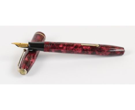 A Conway Stewart 75 fountain pen with rose pearl marbled body and 14ct yellow gold nib, length 12.9cm. CONDITION REPORT: Very