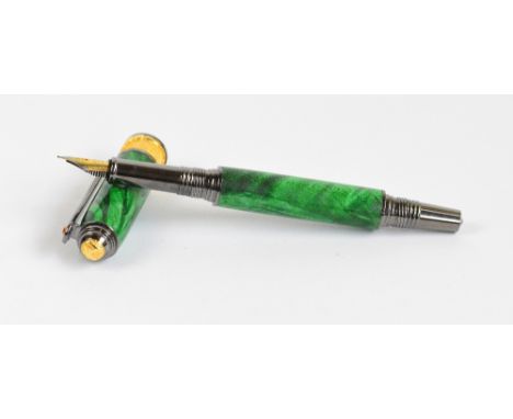 A boxed Lanier fountain pen with green swirl decorated body, "jewel" encrusted clip, and central textured band in yellow and 