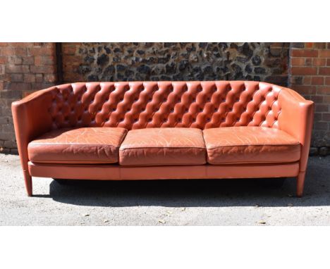 A mid century Italian leather three seater sofa by Minotti, designed by Rodolfo Dordoni, in red leather with button back and 