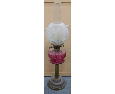 A Victorian brass oil lamp having an etched shade and cranberry glass reservoir, Location: 