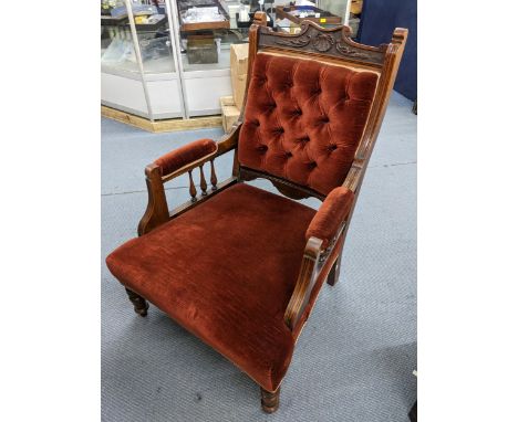 A late Victorian walnut salon armchair having button back upholstery and turned front legsLocation: 