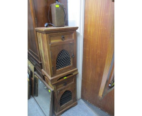 A pair of teak cabinets, together with a contemporary table lamp and a wall hanging mirror Location: 