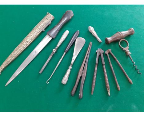 Small metal collectables to include vintage cork screw, button hook, nutcrackers, a Middle Eastern dagger and a pair of treen