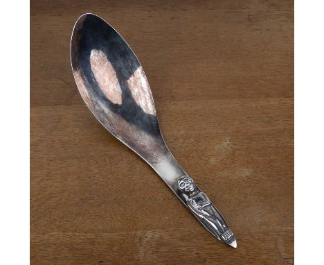 White metal ladle or serving spoon in the Kwakiutl tribal style, with stylised figure handle, with unknown mark to the revers