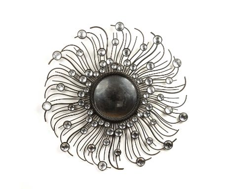 In the manner of Chaty Vallaurismirror with black metal frame and applied decoration, unmarked, the mirror plate measures 23c