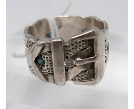 A Gentleman's sterling silver buckle-belt ring set with seven, round, faceted blue diamonds and textured detailing, Ring Size