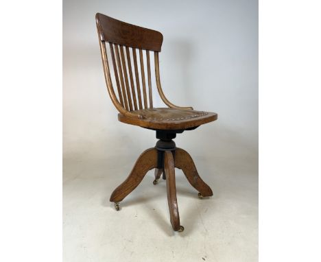 An stick back bentwood Edwardian oak swivel chair with leather seat and metal swivel mechanics, with later brass castors. W:4