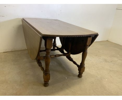 An oak gate leg table with pull out leg supports.W:139cm x D:184cm x H:75cm