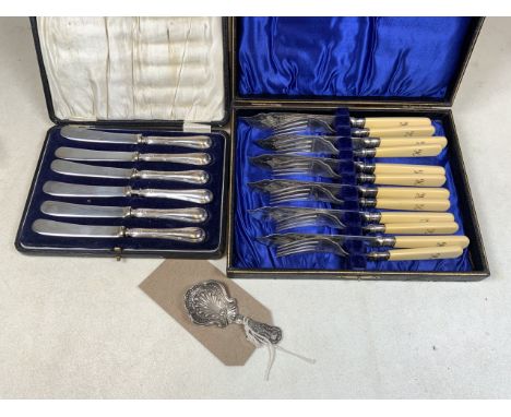 A Cased set of silver handled knives also with silver collared fish knives and forks and silver caddy spoon.
