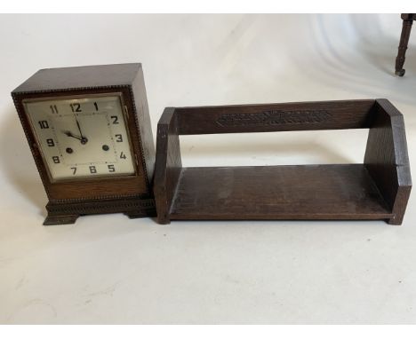 A 1930s Dimra German made mantle clock in oak case with moulded finish also with an early 20th century book slide.