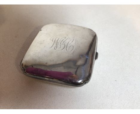 A silver cigarette case hallmarked to interior. Birmingham 1918. Weight approx 96gm. Engraved monogram on lid