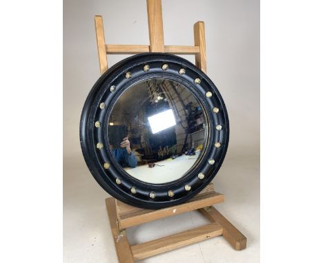An early 20th century black painted circular convex mirror. Decorated with glass buttons. W:42cm x H:42cm