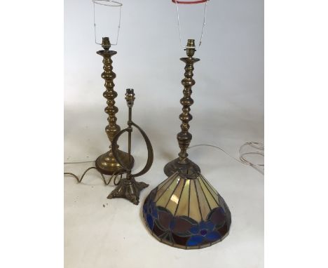 Three brass lamp bases together with a Tiffany style shade (slight damage to one side)H:55cm tallest lamp