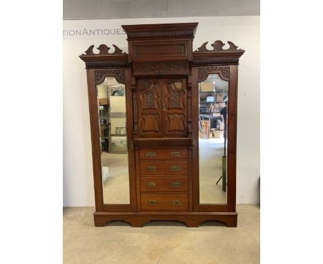 An Art Nouveau mirrored wardrobe with bevelled mirror, large drawer to base W:106cm x D:79cm x H:236cm