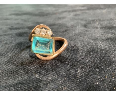 A 9ct twist ring with a trio of diamonds and a blue stone. 