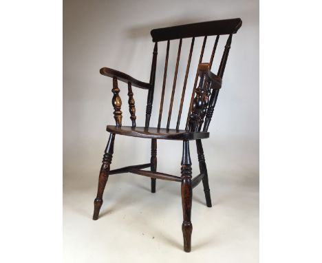 A 19th century elm seated stick back Windsor grandfather chair. Seat height H:45cm