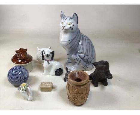 A large hand painted ceramic cat together with a Royal Doulton Westie, a flat back hand painted dog, a plate dish a Doulton s