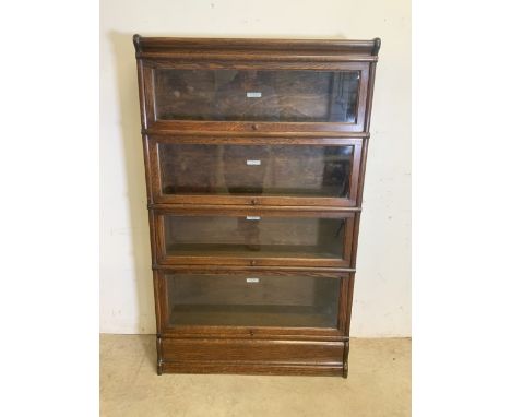 An oak Globe Wernicke bookcase with four sections, top and base. Each section with The Globe Wernicke Co Ltd label. With orig