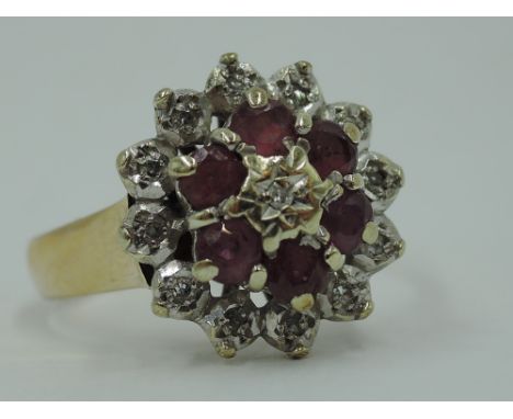 A ruby and diamond chip cluster ring having an illusionary set mount on a 9ct gold loop, size S &amp; 5.2g