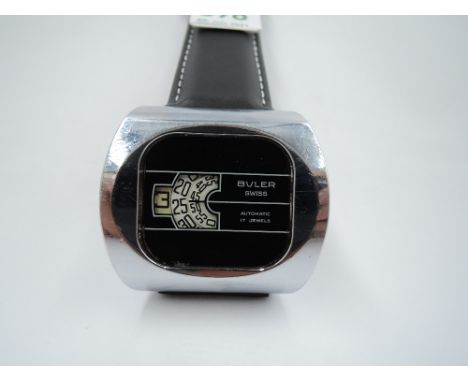 A 1970's automatic wrist watch by Buler having three white rotating window dials with Arabic numerals to a cushioned rectangu