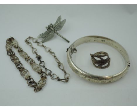 An HM silver hinged bangle having engraved scroll decoration, two decorative silver bracelets, a white metal ring and pin bro