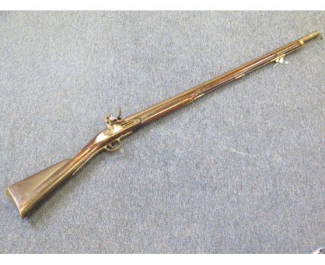 A 19th century trade musket. Plain flintlock lock with ring neck cock. Trigger guard replaced. A good decorative 'Brown Bess;