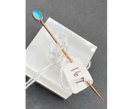 A fine blue opal flashed oval stick pin in high carat with screw top