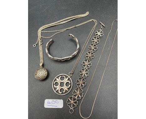 A bag containing two silver Celtic style necklaces with pendant and silver bangle and silver floral link bracelet 67 gms