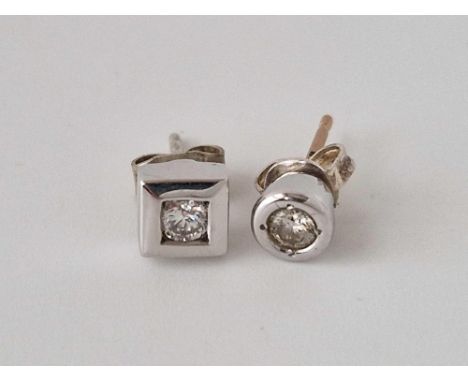 Two odd diamond and white gold earring studs in circular and square settings, 1.5 g inc