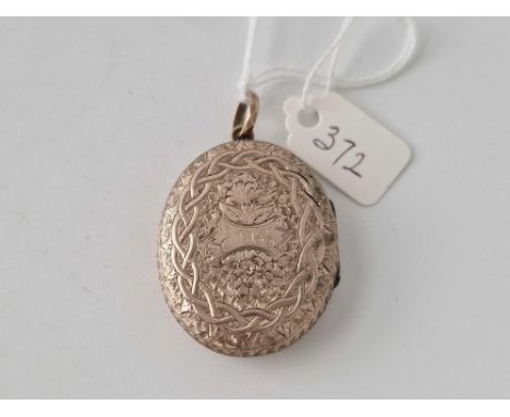 A gold oval engraved locket slight split