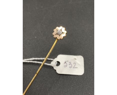 A fine antique diamond stick pin in floral daisy flower setting