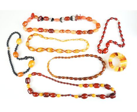 A collection of vintage amber style beaded necklaces and bracelets. 