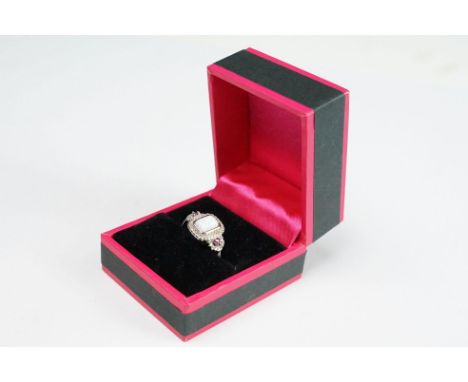 Silver CZ and opal central panel ring with ruby shoulders 