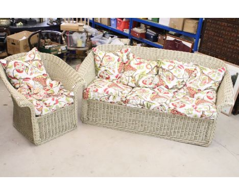 Wicker sofa and matching armchair with associated loose cushions. Sofa measures 174 x 85cm. Arm chair 84 x 88cm. 