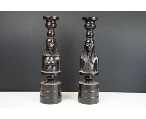 Vintage pair of tribal ebony hand carved male and female wooden candlestick holders on round bases, H 35.5cm 