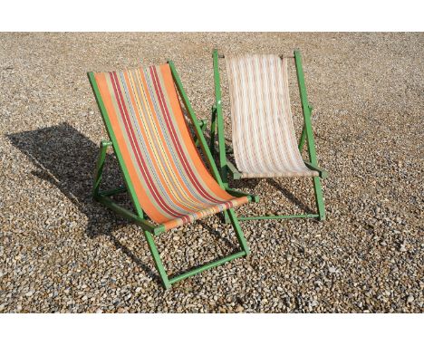 Two vintage folding painted wooden deck chairs with striped canvas seats