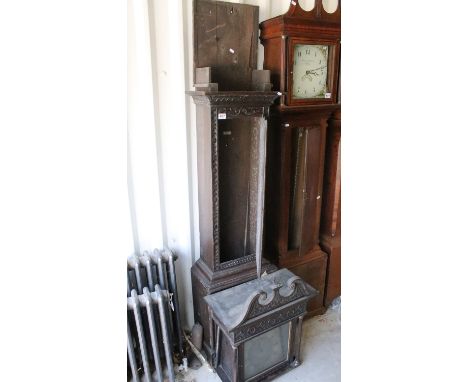 Dark oak carved longcase grandfather clock with swan neck pediment, bird finial to centre, decorative columns with brass deta