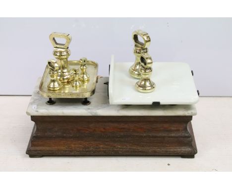 Victorian butcher shop grocer scales with set of brass weights. Carved wood base with marble slab, scale platforms in porcela