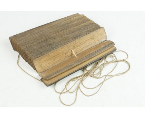 Indonesian palm leaf manuscript, having carved wooden covers with etched lettering to each leaf within. 