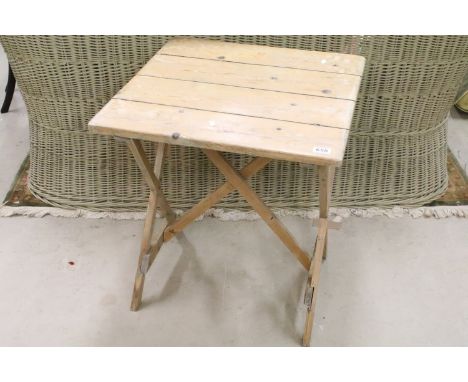 Vintage scrubbed pine table having a square slatted top raised on crossed legs. Measures 68 x 60 x 62cm.