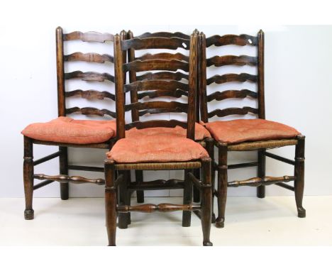 Set of four ladder back chairs with woven rush seats, turned legs and stretcher 