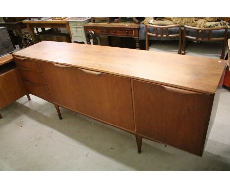 Mcintosh of Kirkaldy vintage teak sideboard having a twin doored cupboard to centre with three drawers and one drop door, all
