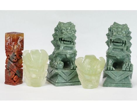 A collection of carved Chinese ornaments to include a pair of dogs of foo together with a carved seal. 