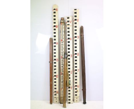 Vintage surveyor's telescopic measuring sticks, rulers and tripod 