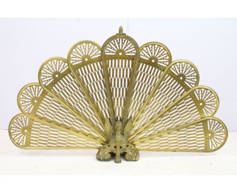 Brass extending peacock firescreen, 57cm high x 95cm wide 