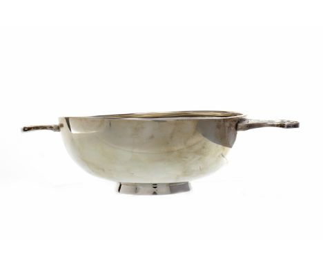 CONTEMPORARY SILVER QUAICHmaker Wakely & Wheeler, London 1977, the footed circular bowl with twin Celtic handles, 24cm wide, 