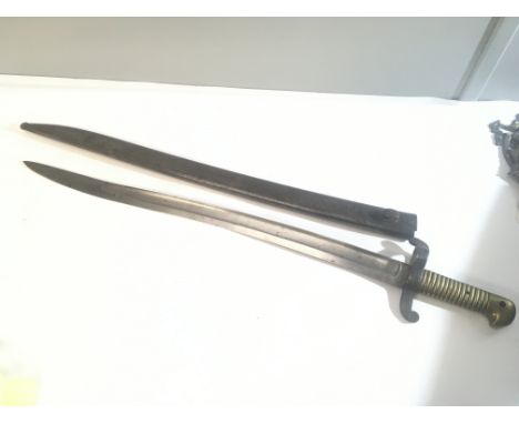 A French 1856 pattern bayonet stamped 1856 to the steel Yataghan blade brass grip and steel scabbard.