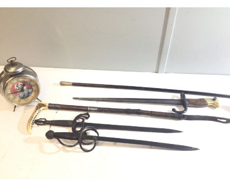An 1887 pattern bayonet a swagger stick Royal Engineers a silver mounted riding crop an alarm clock and two short ornamental 