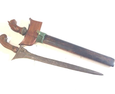 A late 19th or early 20th century Indonesian Kris with a Damascus type wave edge blade and wooden handle (2)